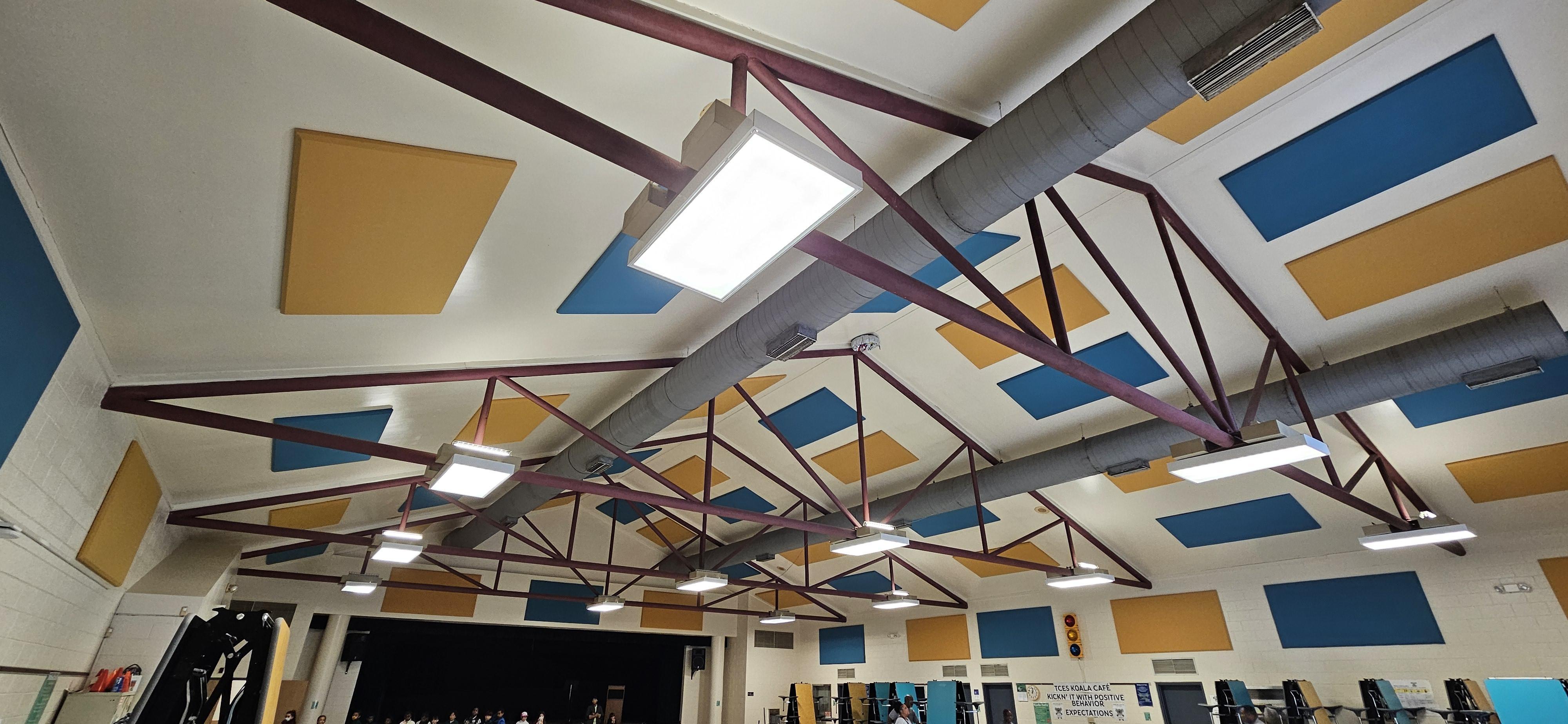 To improve speech intelligibility and reduce echo in their cafeteria, Tanner Creek Elementary School installed fabric wrapped panels on the walls and ceiling.
