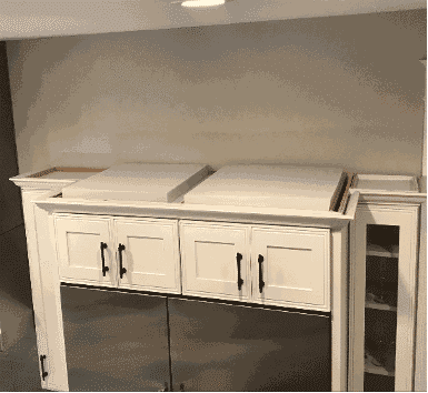 Acoustic panels placed on top of kitchen cabinets