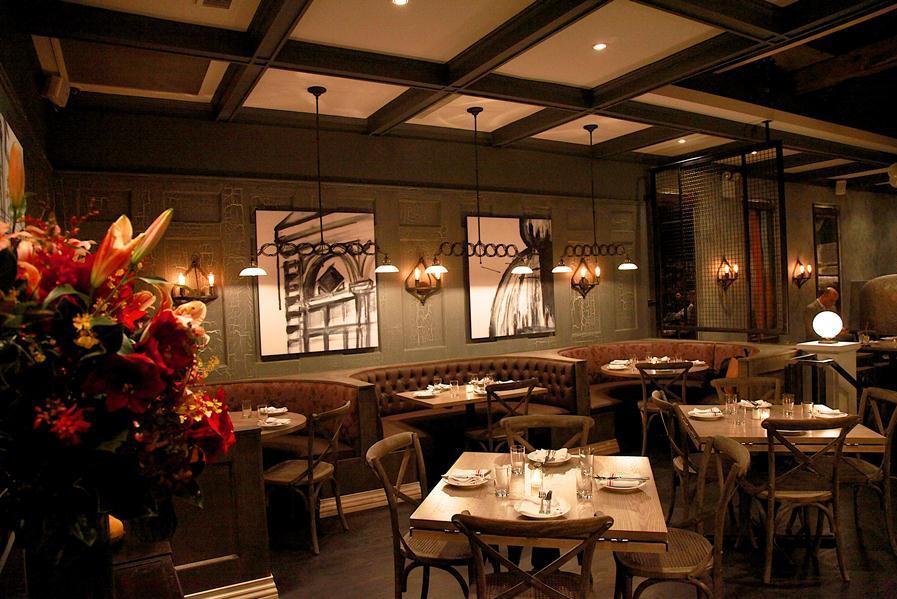 Custom fabric wrapped art panels line the walls at Sotto 13 to reduce reverberation in the dining room.