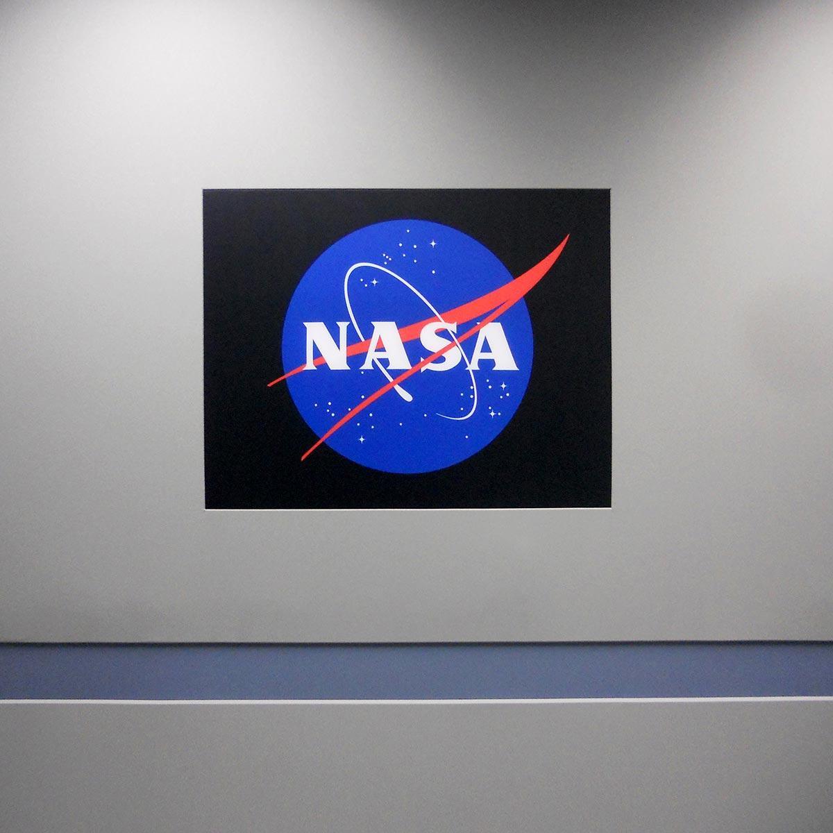 Logos printed on fabric may be used in entryways, lobbies and corporate board rooms, as shown in this example at NASA.