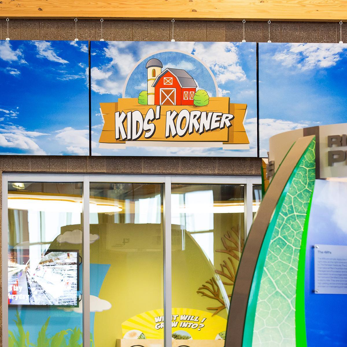 AgroLiquid Exhibit Room showcases double sided acoustical art panels mounted as baffles to reduce the echo in this display area.