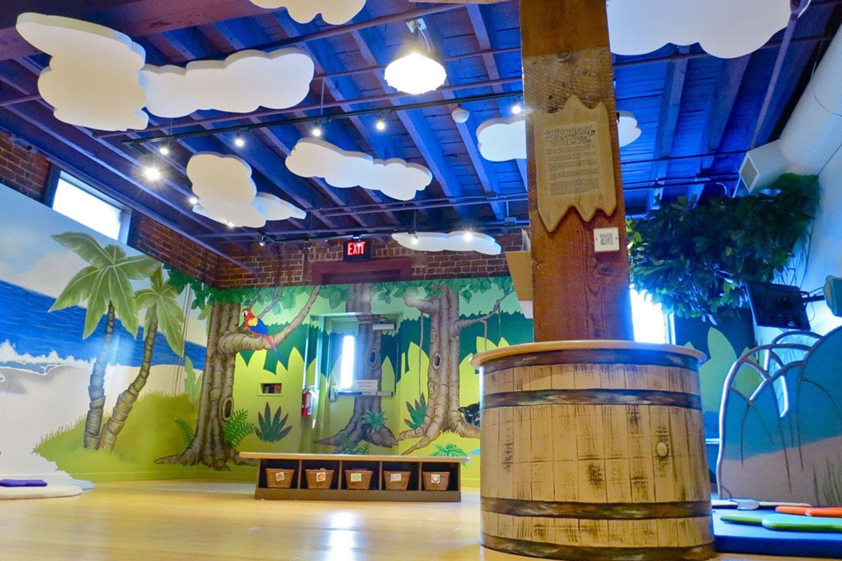 Acoustic clouds hanging from the ceiling in a toddler development room in the Amazement Square Children's Museum. 