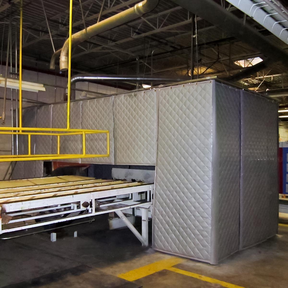 PrivacyShield Absorptive Soundproofing Blankets were installed to create a sound enclosure around the equipment in this lumber processing plant.
