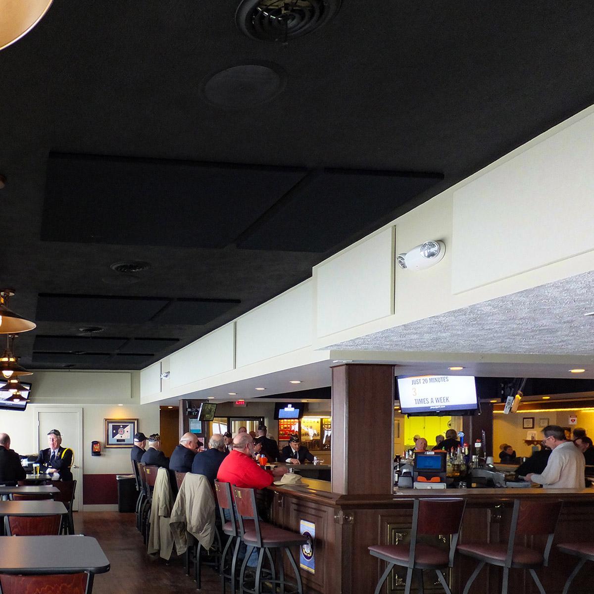 American Legion Post #28 installed a series of black and white acoustic panels on the walls and ceiling of their bar and dining area.