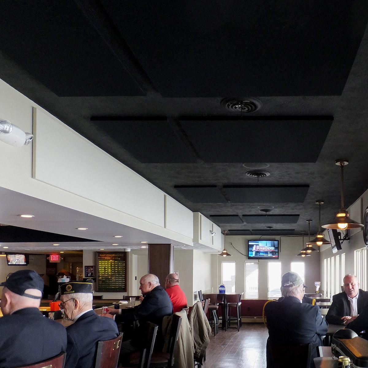 At the American Legion Post #28 bar,  fabric wrapped acoustic panels were installed to improve speech intelligibility in the space.