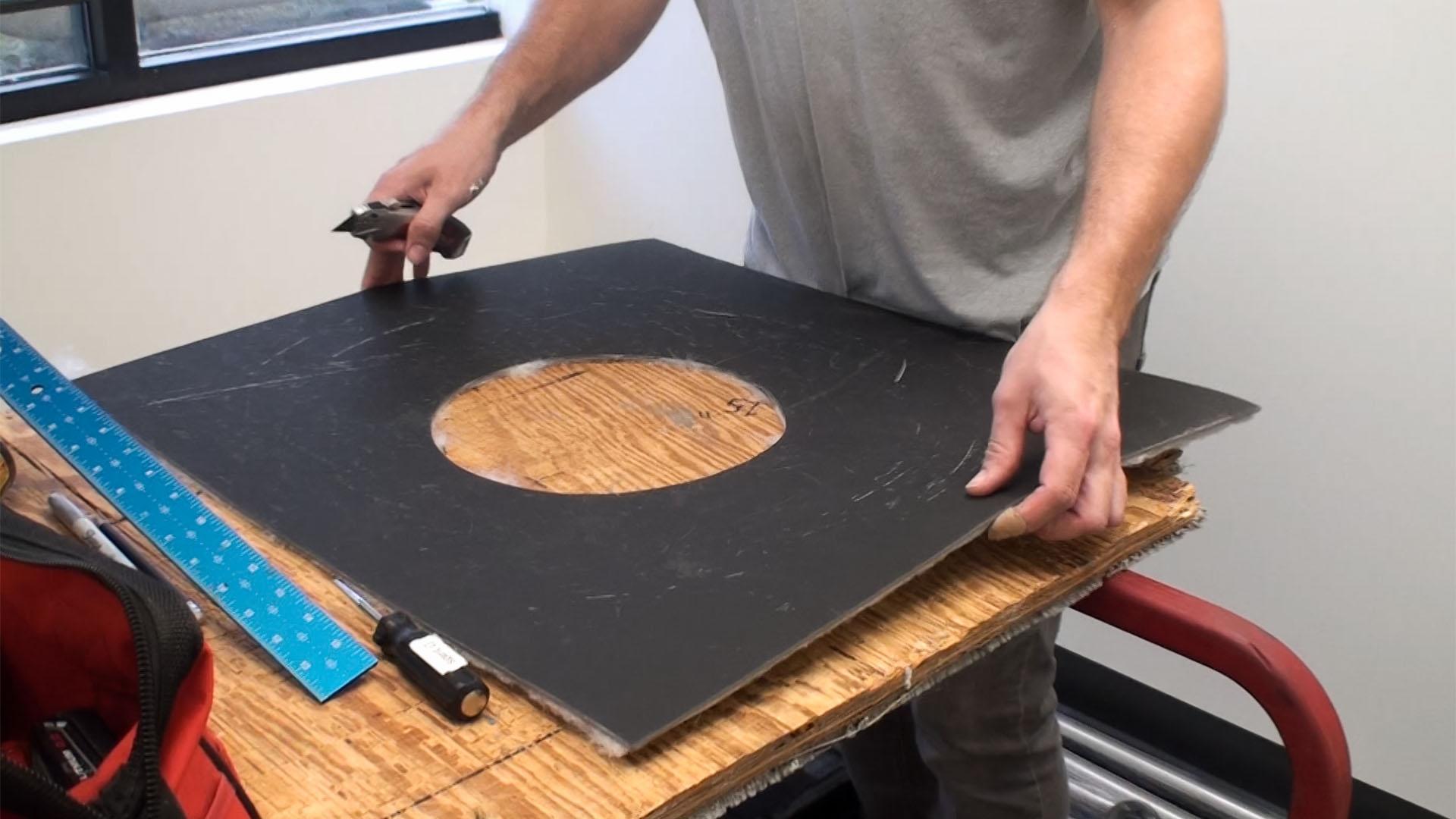 A completed circle cutout in a Ceiling Tile Barrier