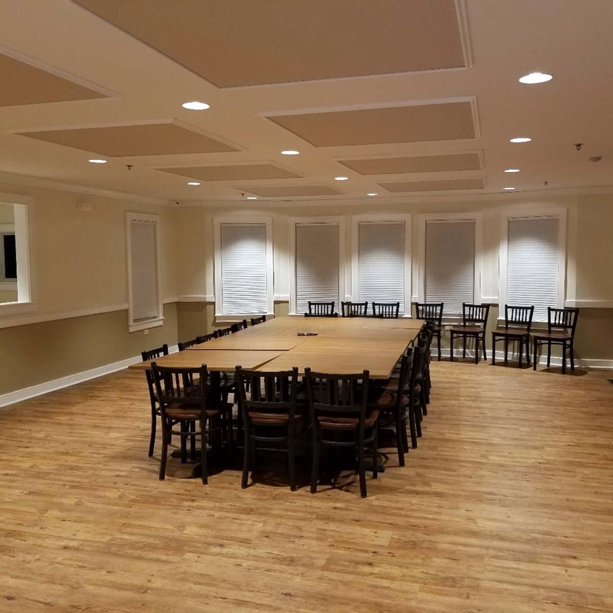 A country club conference room with custom acoustic high impact fabric wrapped panels on the ceiling.