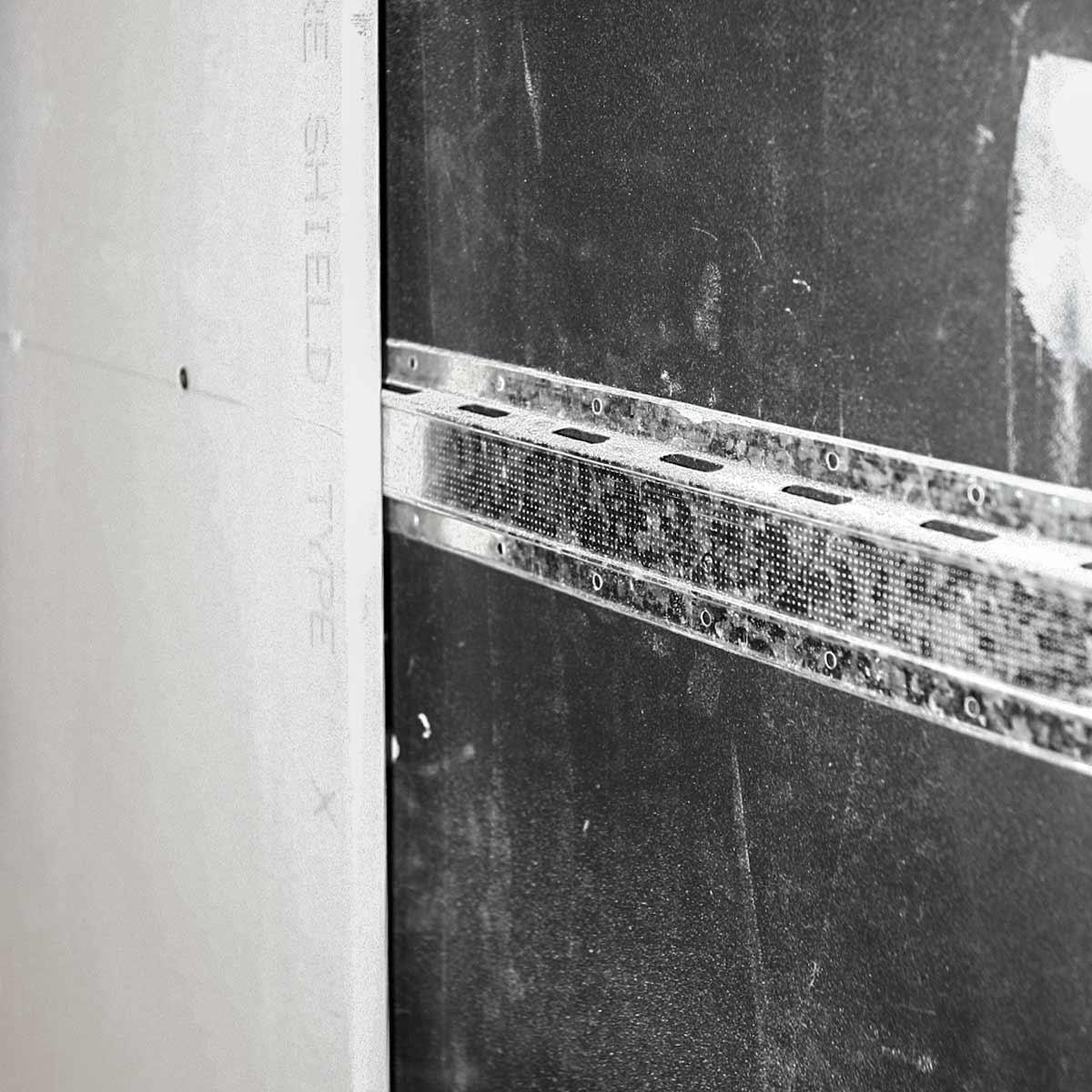 Soundproofing a Garage — Layer of mass loaded vinyl, double leg resilient hat channel and layer of drywall.