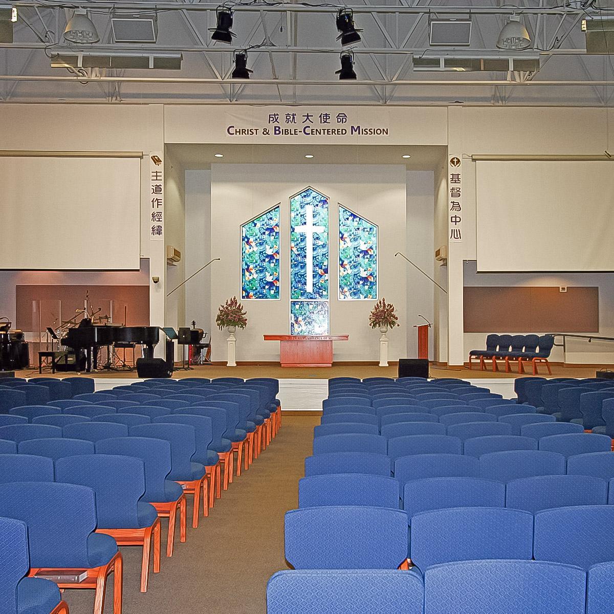 Fabric wrapped acoustic panels line the walls of the worship space of the Chinese Bible Church of Maryland to reduce noise in the space.