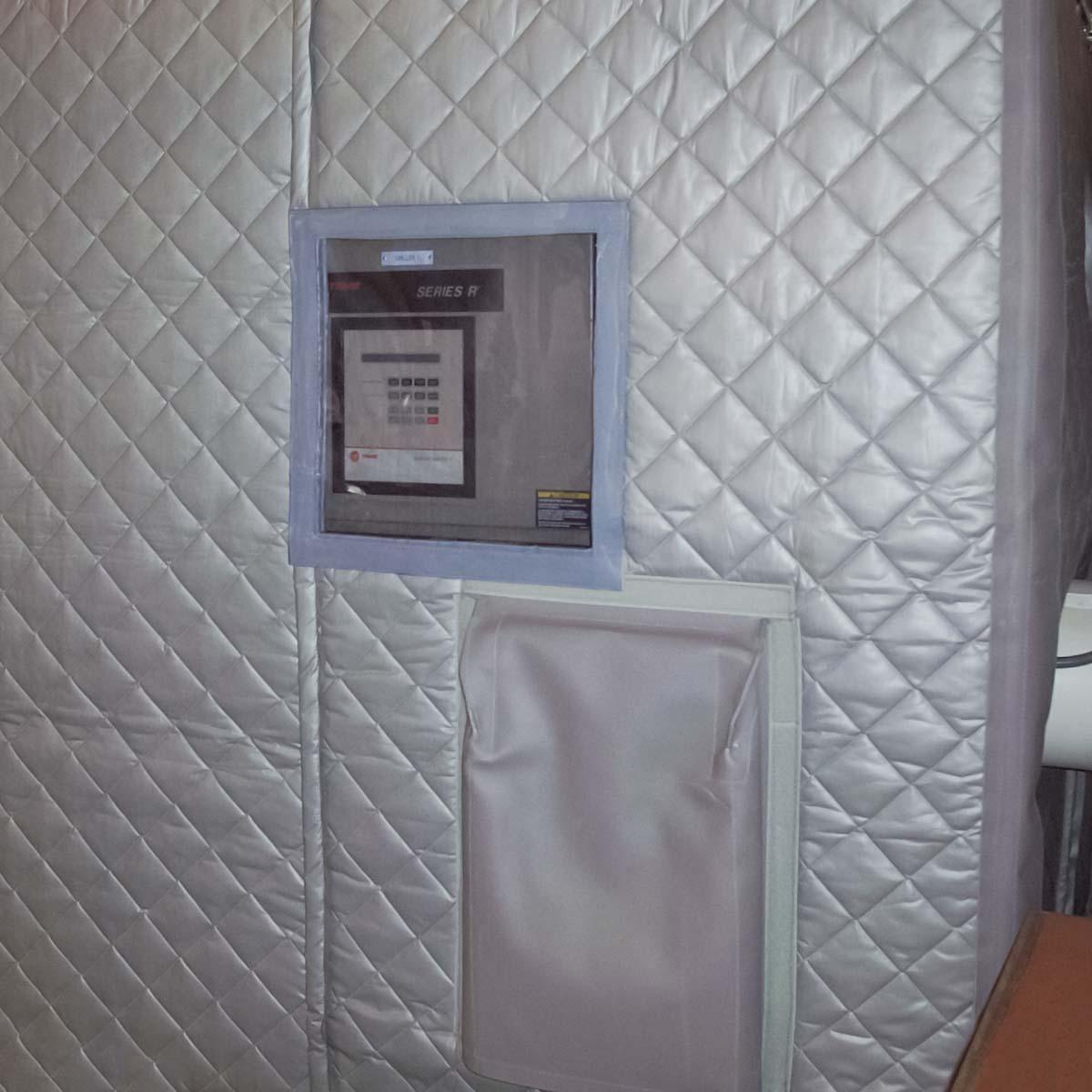 A PrivacyShield® Dual-Sided Absorptive Soundproofing Blanket enclosure reduces chiller noise at the Christopher Newport University dormitories. A transparent access was added to access the control panel.