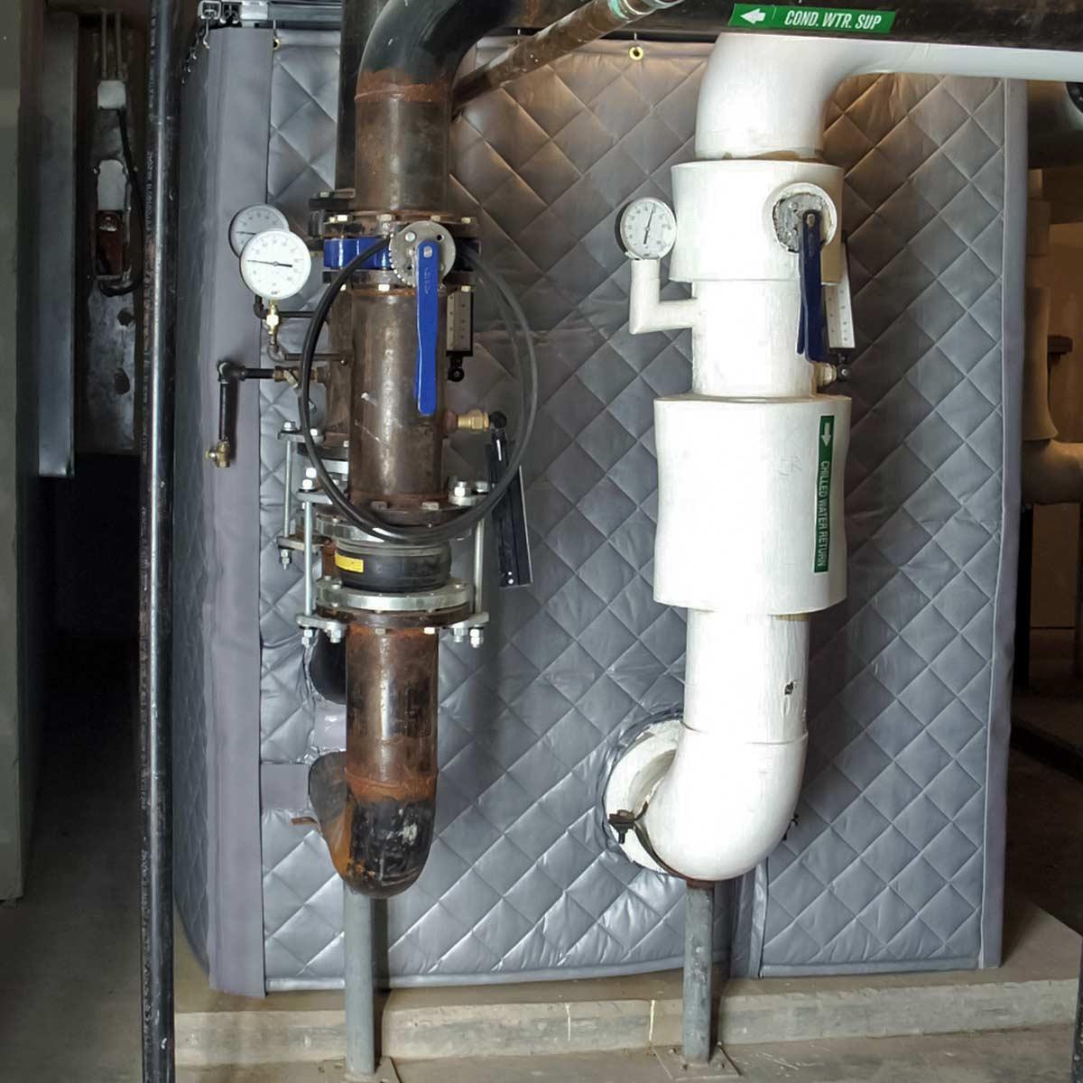 A PrivacyShield® Dual-Sided Absorptive Soundproofing Blanket enclosure reduces chiller noise at the Christopher Newport University dormitories.