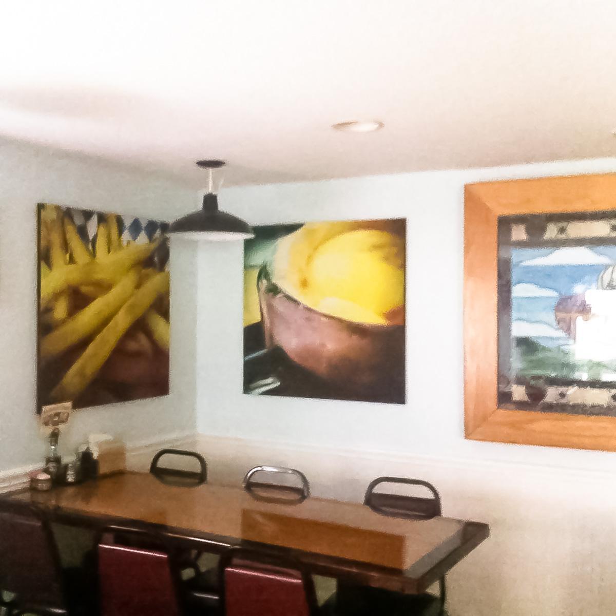 At Clay's Café, custom printed acoustic art panels on the walls reduce loud noise in the dining room.