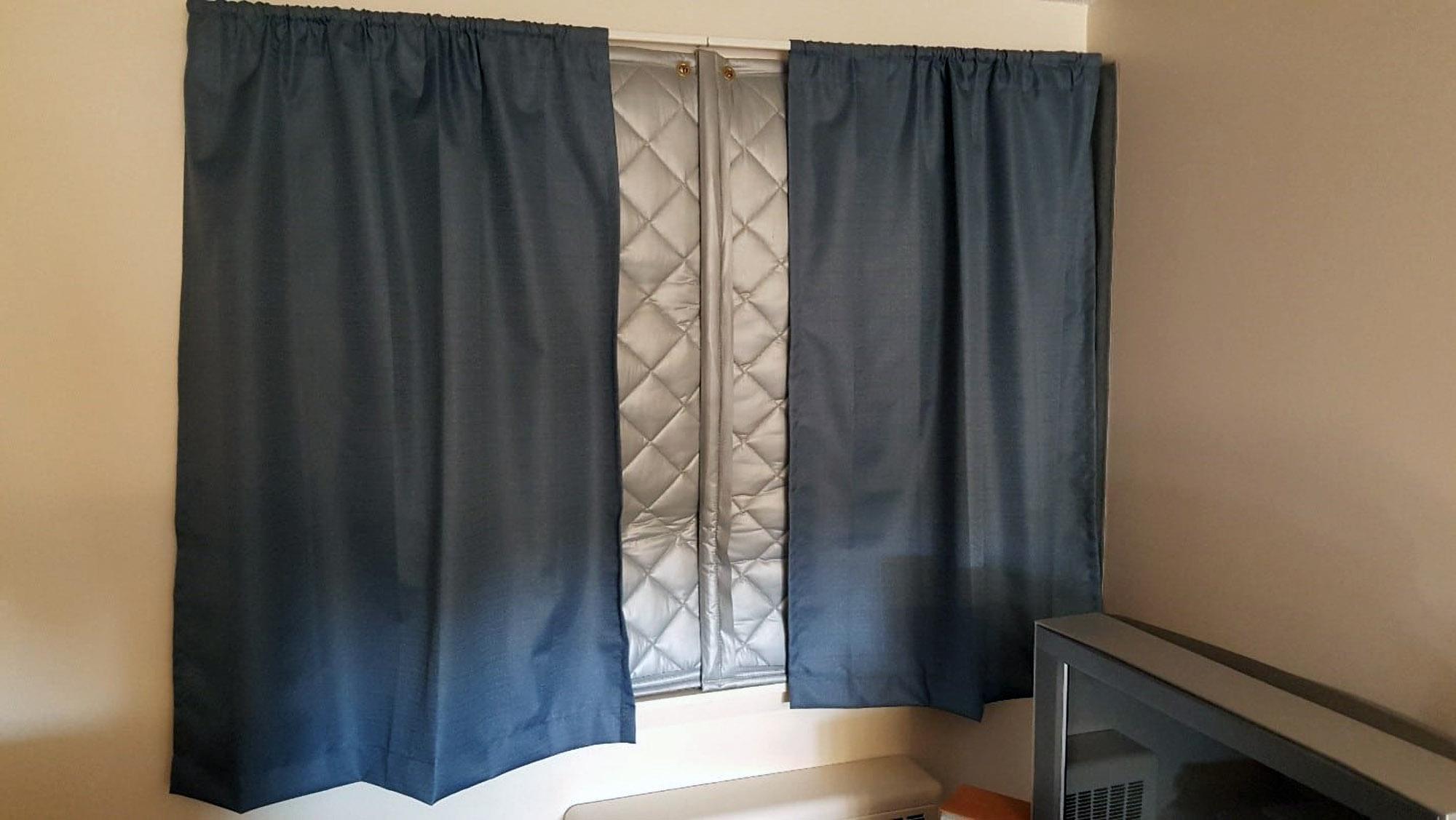 Curtains are used in conjunction with a PrivacyShield® Sound Blanket in a residential window installation
