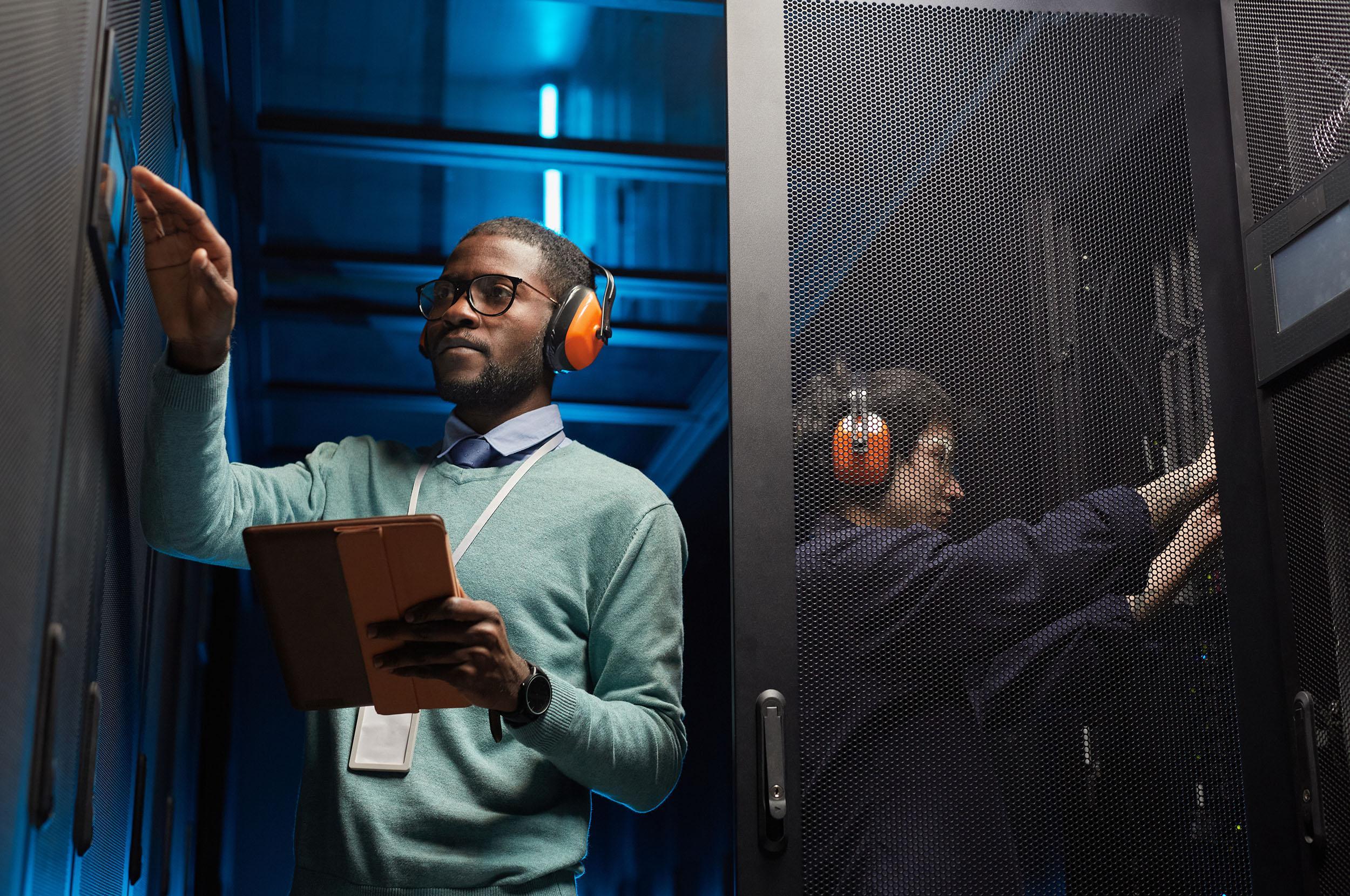 IT Engineers Working in Server Room