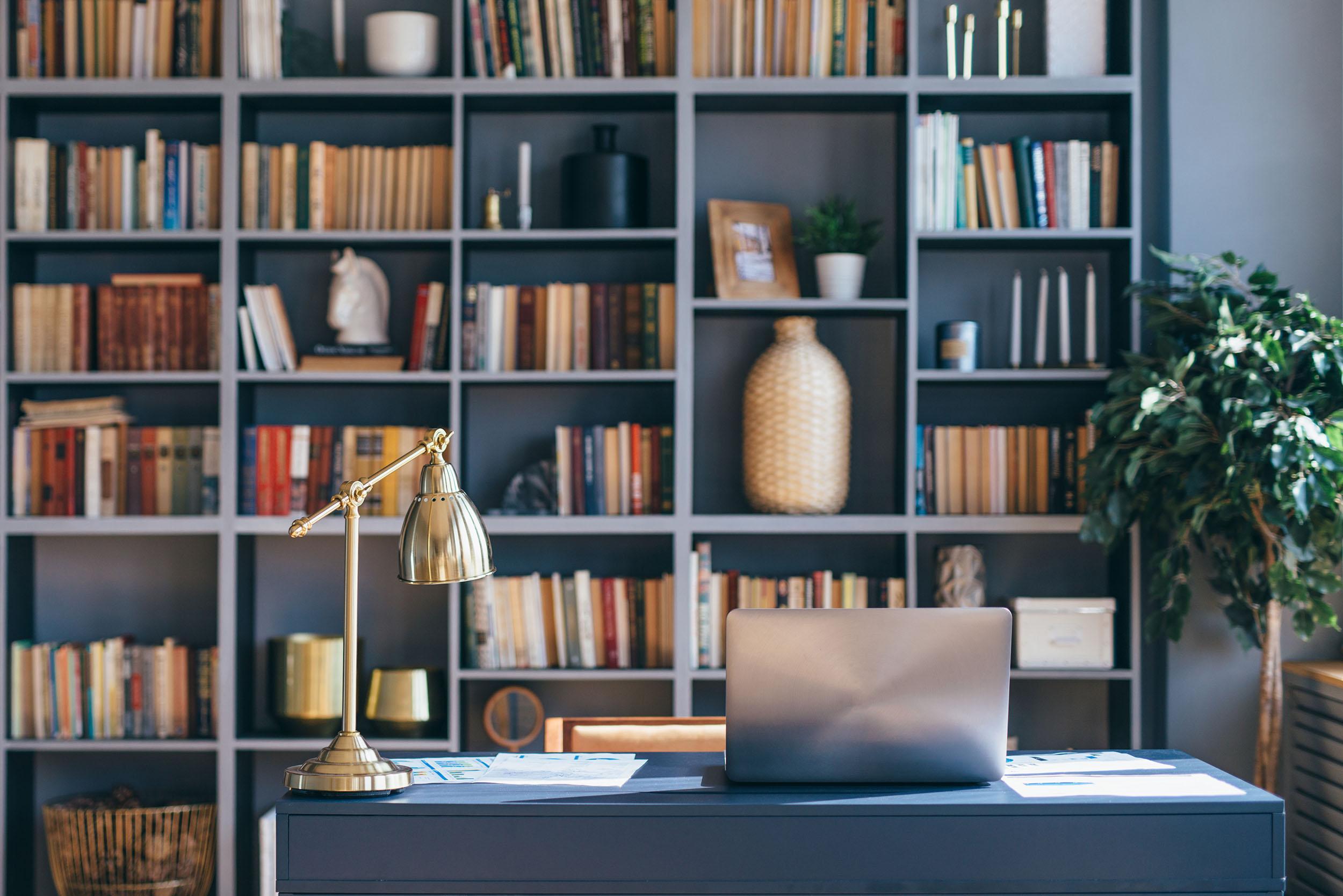 Table with laptop in home office interior. Photo by Undrey at iStock.