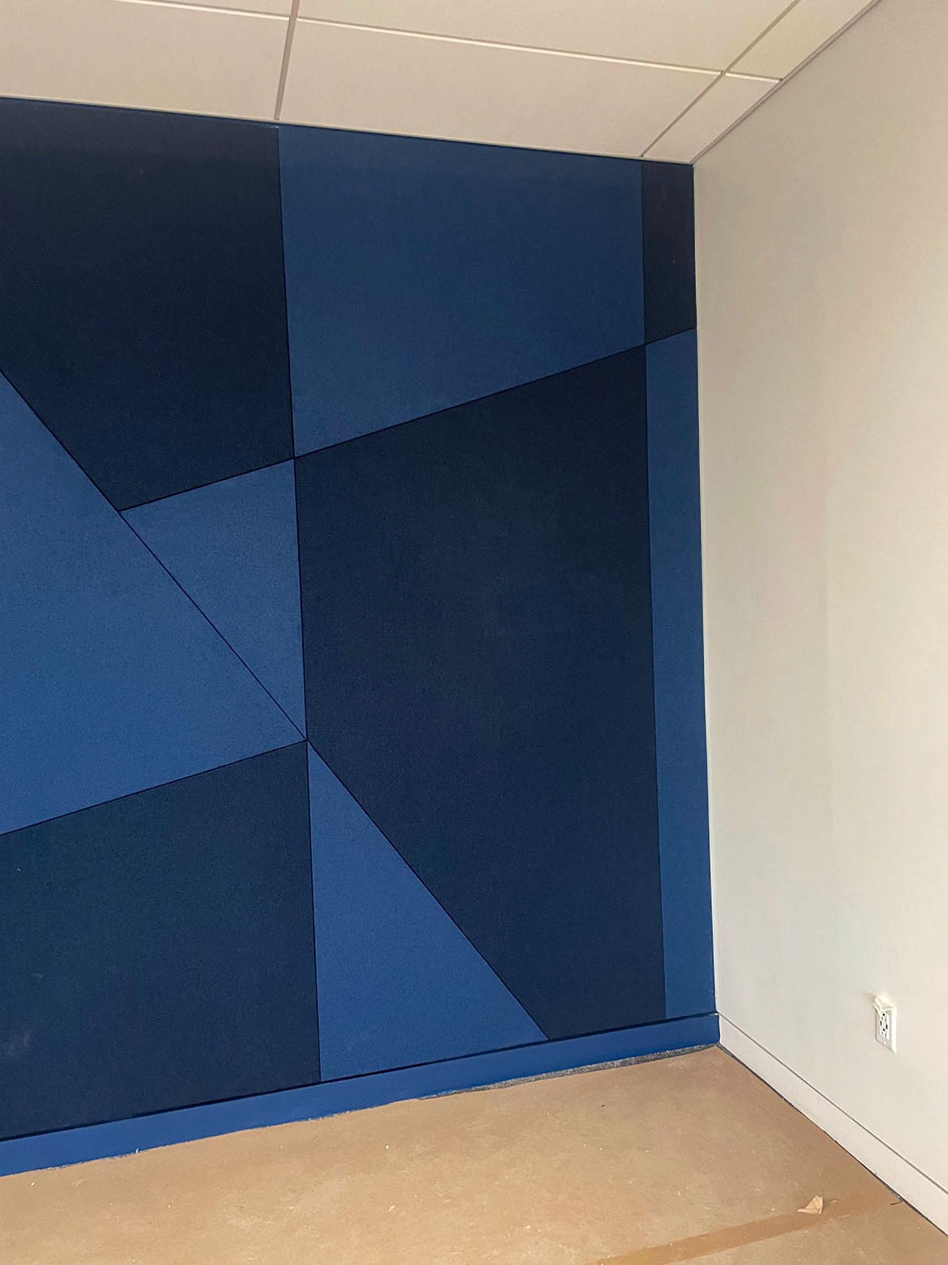 Closeup of Acoustiwall installation at EAB headquarters with custom geometric design