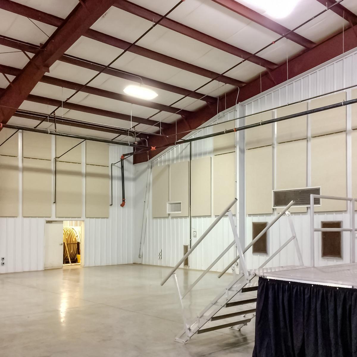 View of stage stairs and acoustic panels installed on wall of Fannin County Community Event Space