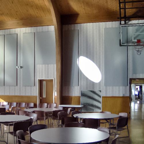 Acoustic fabric wrapped panels installed in a fellowship hall improve speech intelligibility in the space.