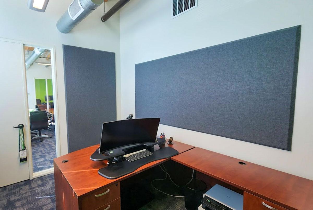 The offices of GT Aubert Construction feature wall-mounted acoustic panels wrapped in fabric for sound absorption.