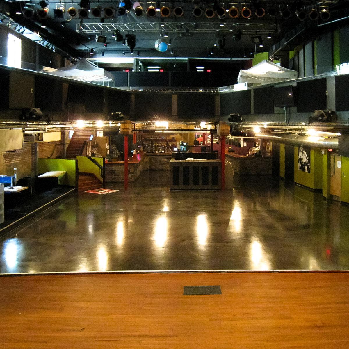 View of balcony, back bar, and black sound absorbing panels in live music venue.