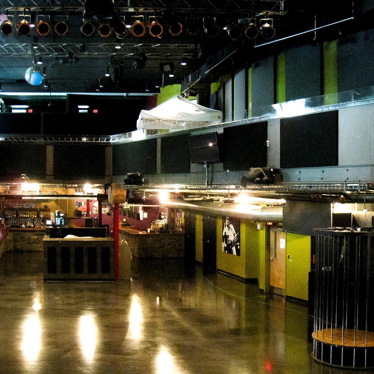 View of bar, polished concrete floors, and fabric warpped panels applied to upper walls surfaces at live music venue
