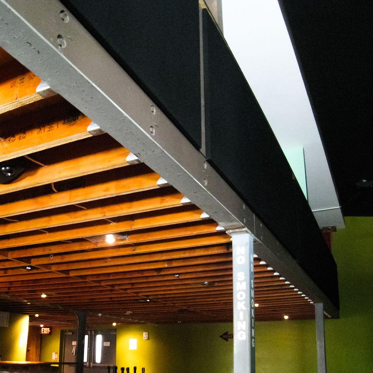 View of wooden beams, steel framework, and acoustic panels at The Hat Factory