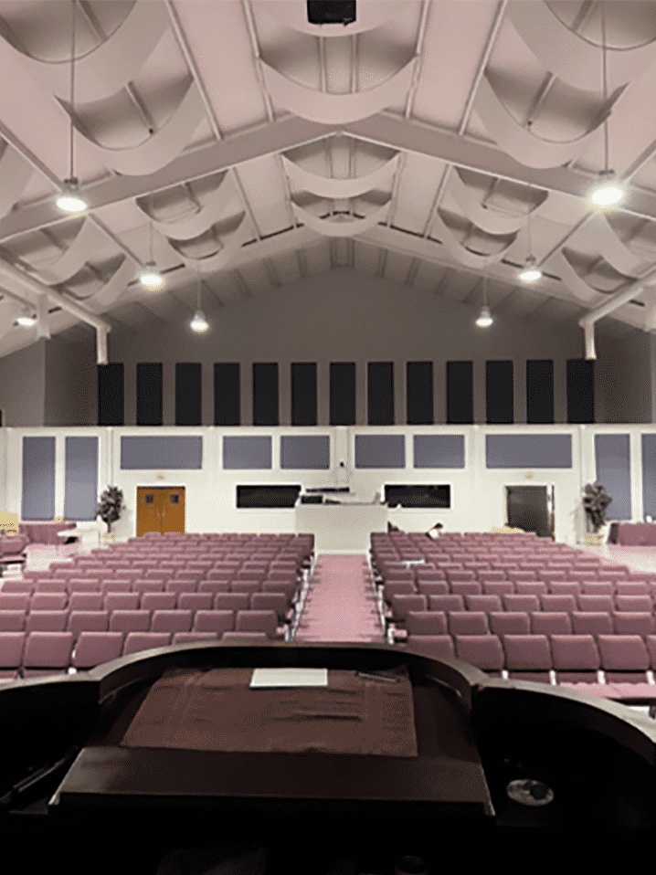 Fabric wrapped acoustic panels reduce echo in a church. 