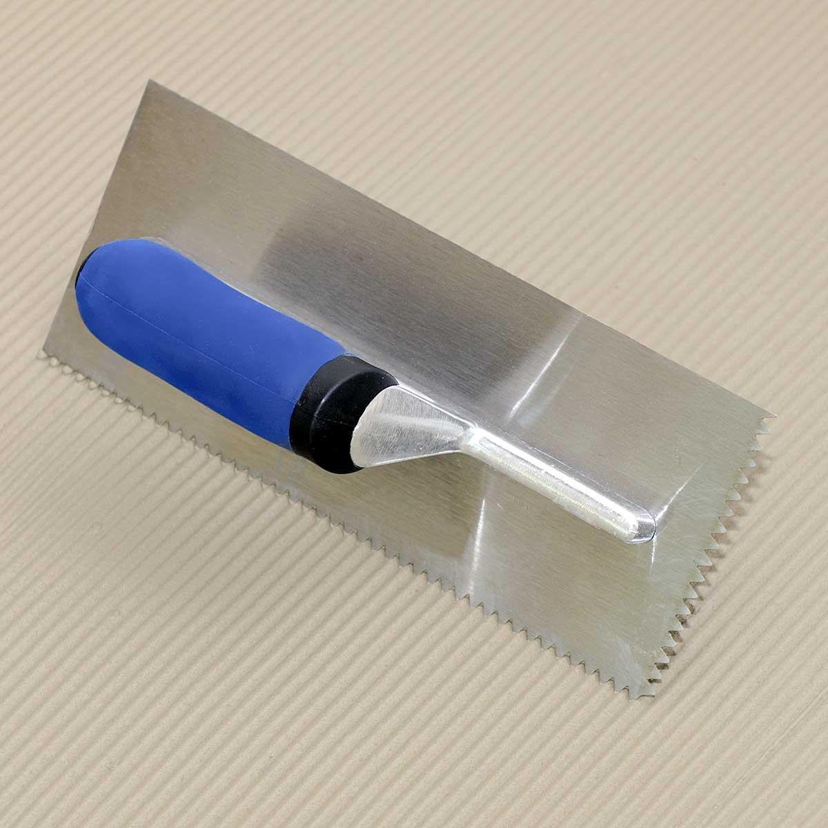 After installing a perimeter isolation strip, apply approved adhesive to the sub-floor using recommended trowel size.