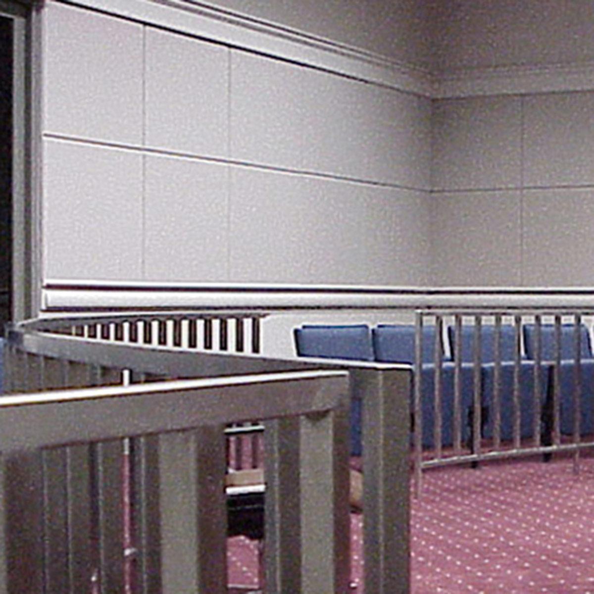 Fabric wrapped wall panels and sound barriers reduce sound in a court room.