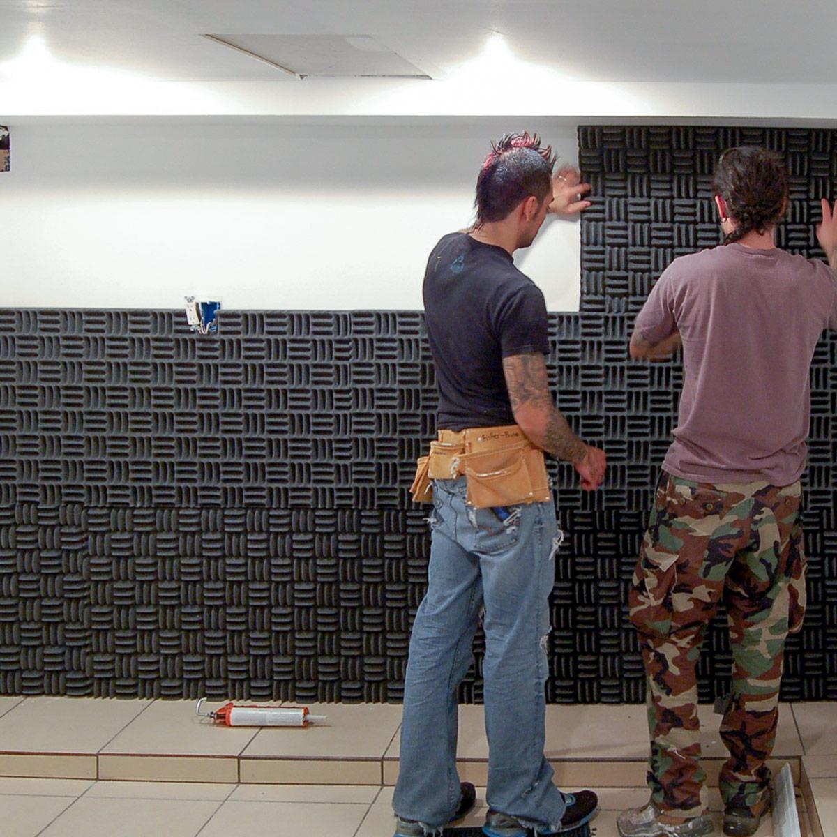 Acoustical foam lines the wall in Jose Mangin's basement to soundproof the space.