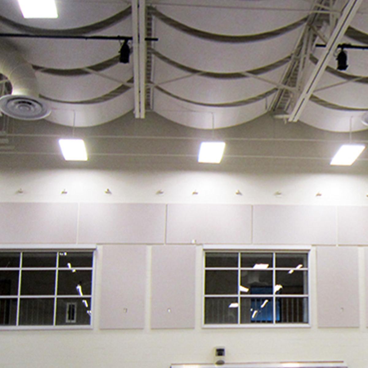 Acoustic banners and wall panels in a church gymnasium reduce reverb in the space.