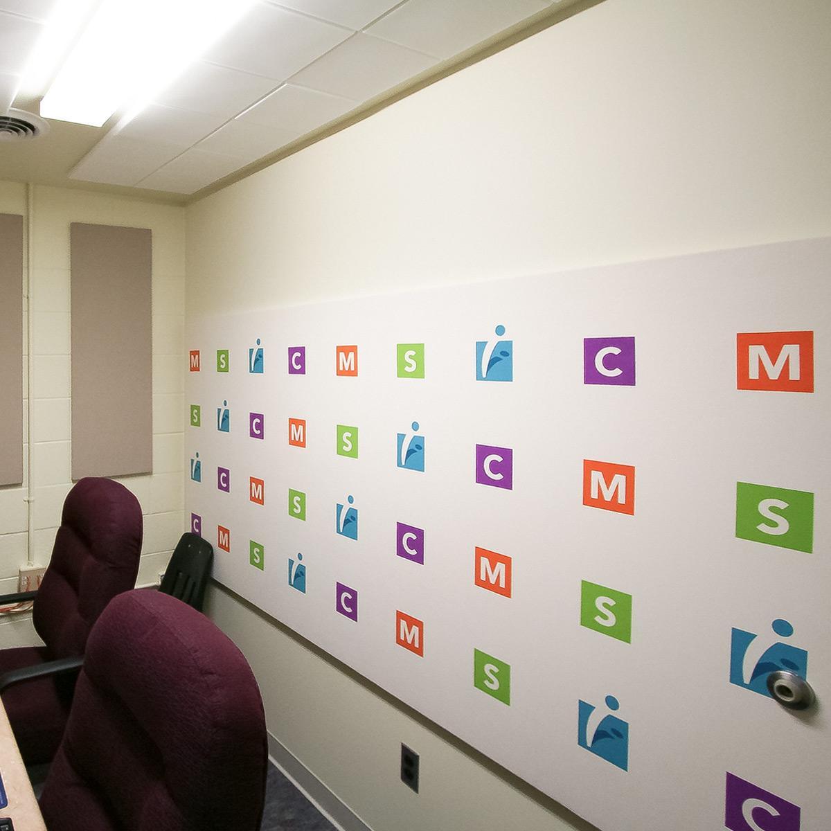 Fabric wrapped panels with a custom art background reduce echo and reverberation in the MathScience Innovation Center.