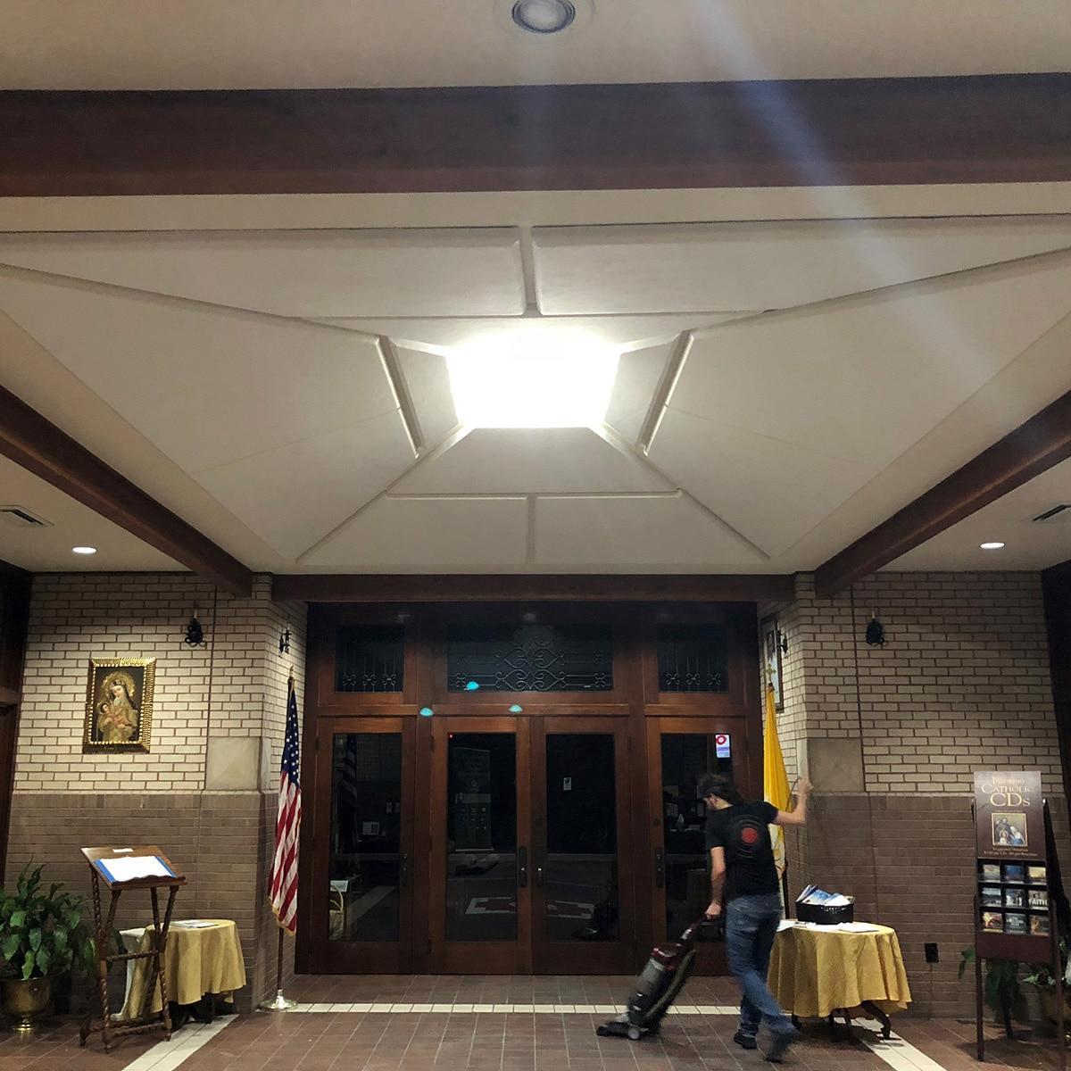 Acoustic fabric wrapped panels on the ceiling at Miracle Faith Center reduce echo in the lobby.