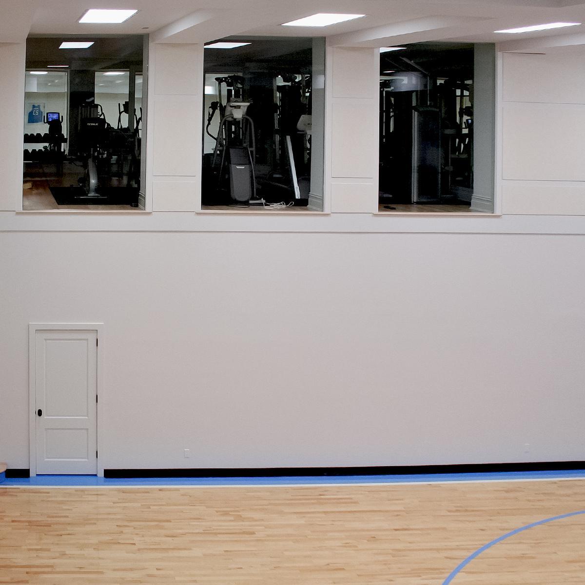 NFL Retiree’s Basketball Court - Combination workout room and home gymnasium with sound control.