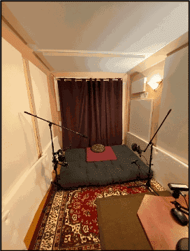 Fabric wrapped panels on the wall and ceiling of a podcast studio.