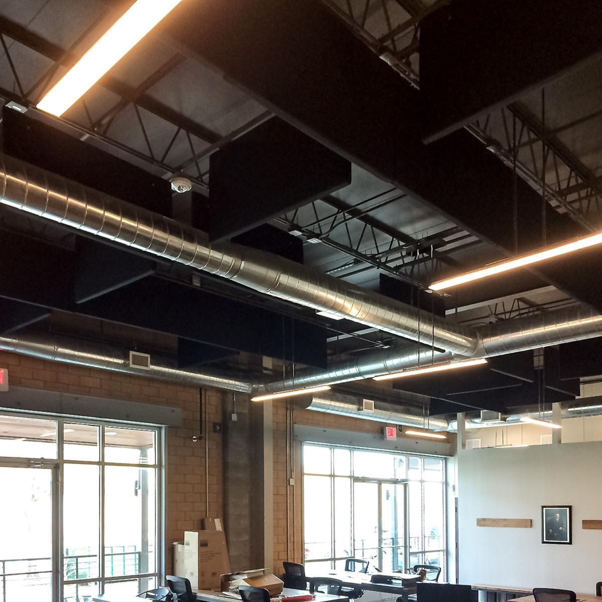 Open office with hanging sound baffles.