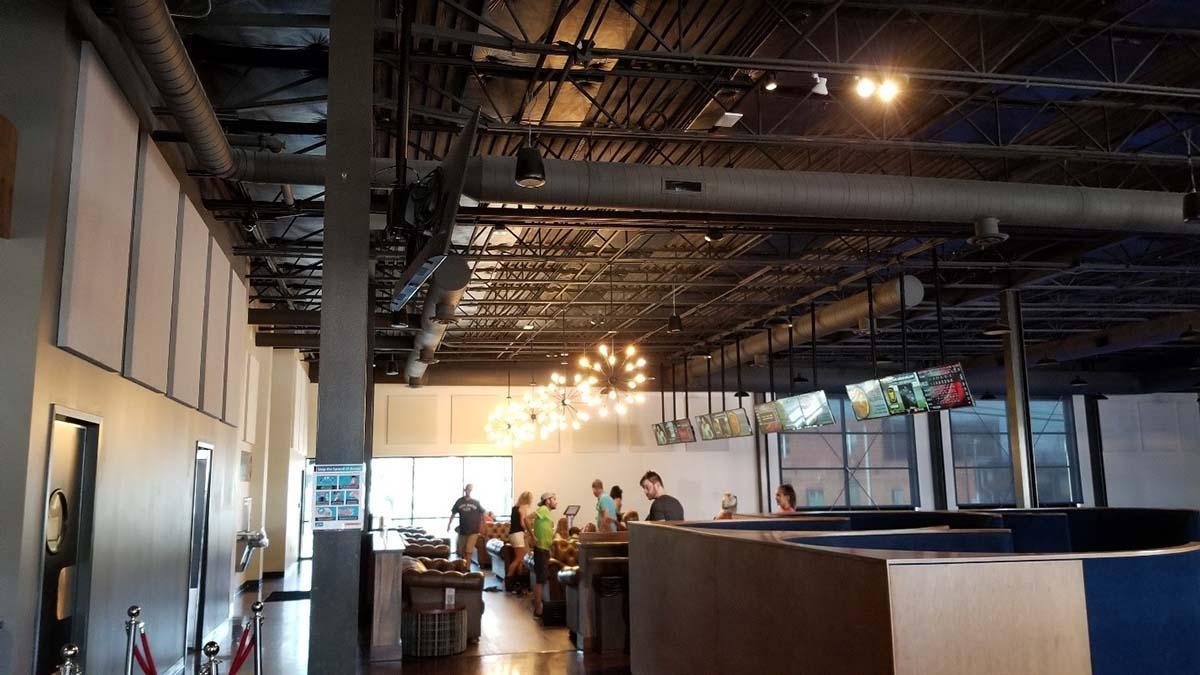 Bowling alley seating area with sound absorbing wall panels