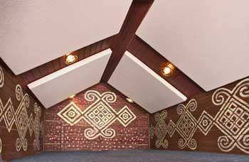 At Kimchee Records,' fabric wrapped panels hang from the ceiling to treat listening problems in the control room.