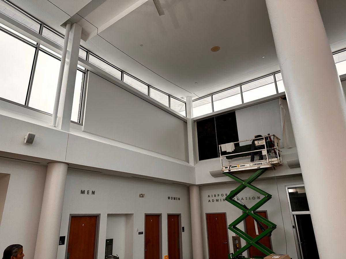 Acoustiwall system being installed in the entrance lobby of an aviation facility