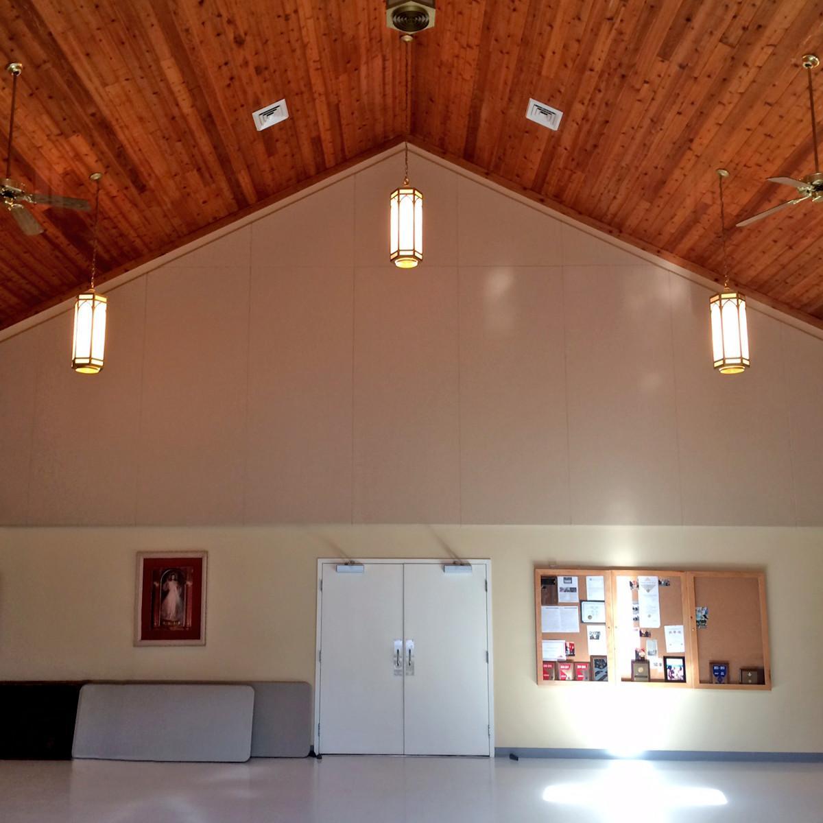 Custom manufactured fabric wrapped panels sized to fit an angled ceiling.