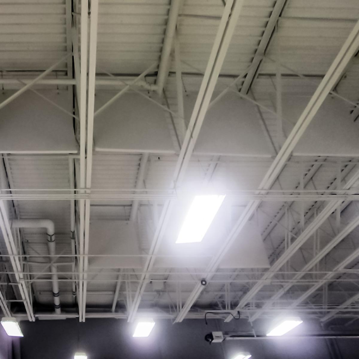 White PVC ceiling sound baffles treat the echo problem in the Sam Leman Auto Repair Shop.