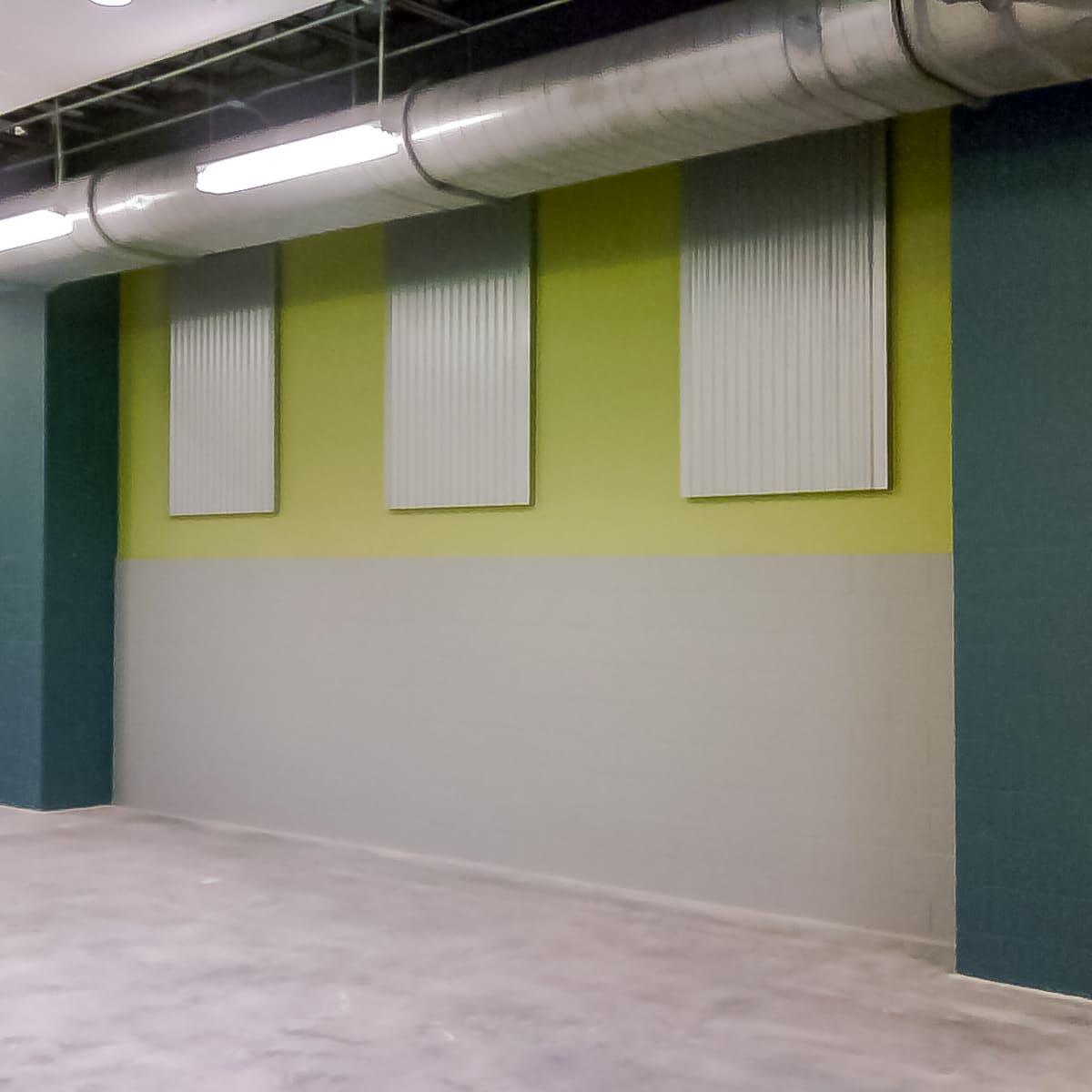 Shaw Modular Solutions using AlphaPerf® panels for industrial look to reduce room noise in school cafeteria.