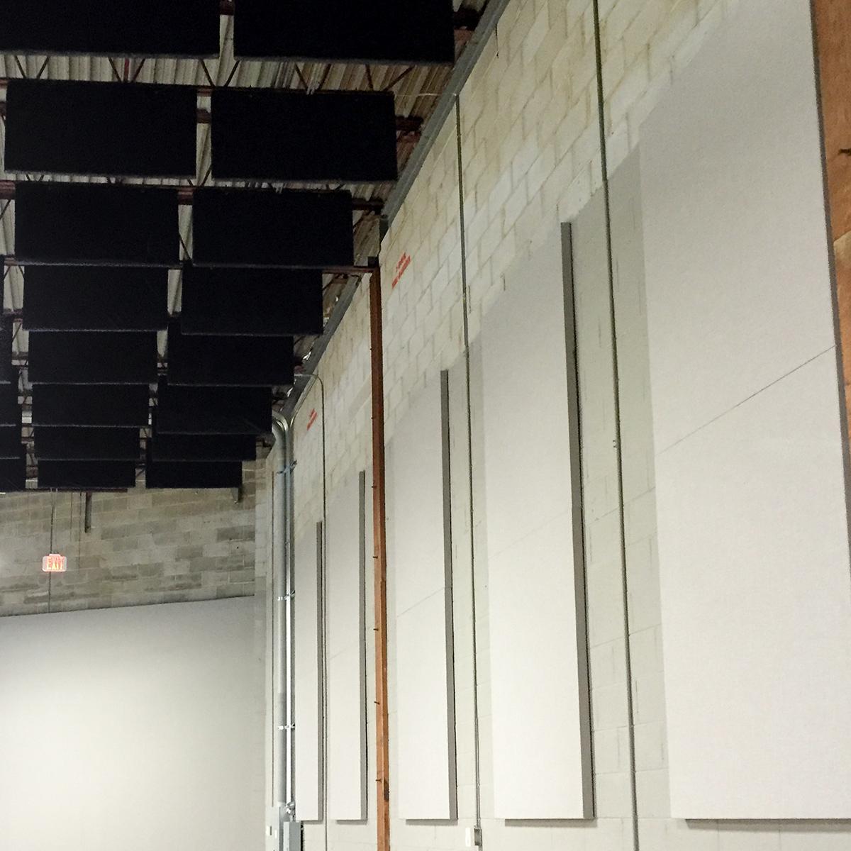 Spang TV installed 4' x 5' x 2 in. thick fabric wrapped acoustic panels around the perimeter wall in the main production space to absorb sound and create a dynamic space for filming.