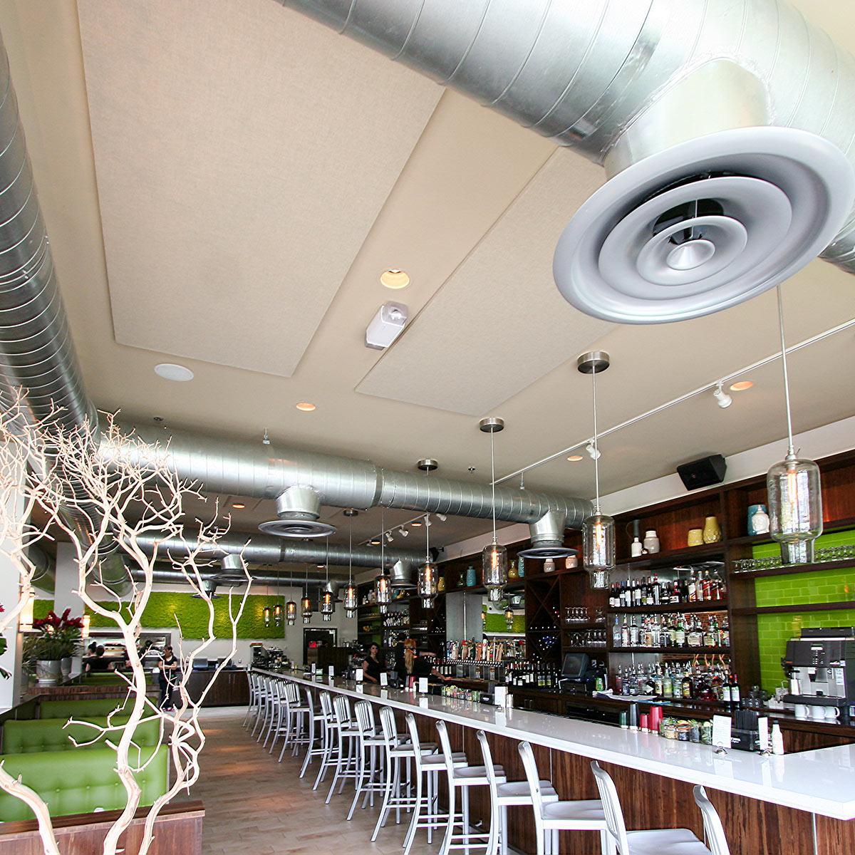 Acoustic panels installed in the ceiling of a restaurant reduced loud noise levels in a restaurant and open bar.