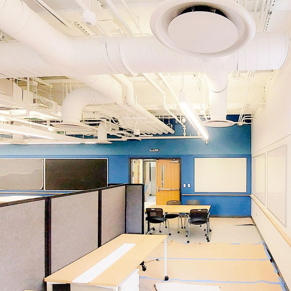 Blue Acoustic Felt Wall Panels above the chalkboards and white panels above the whiteboards installed in the UVA Physics building