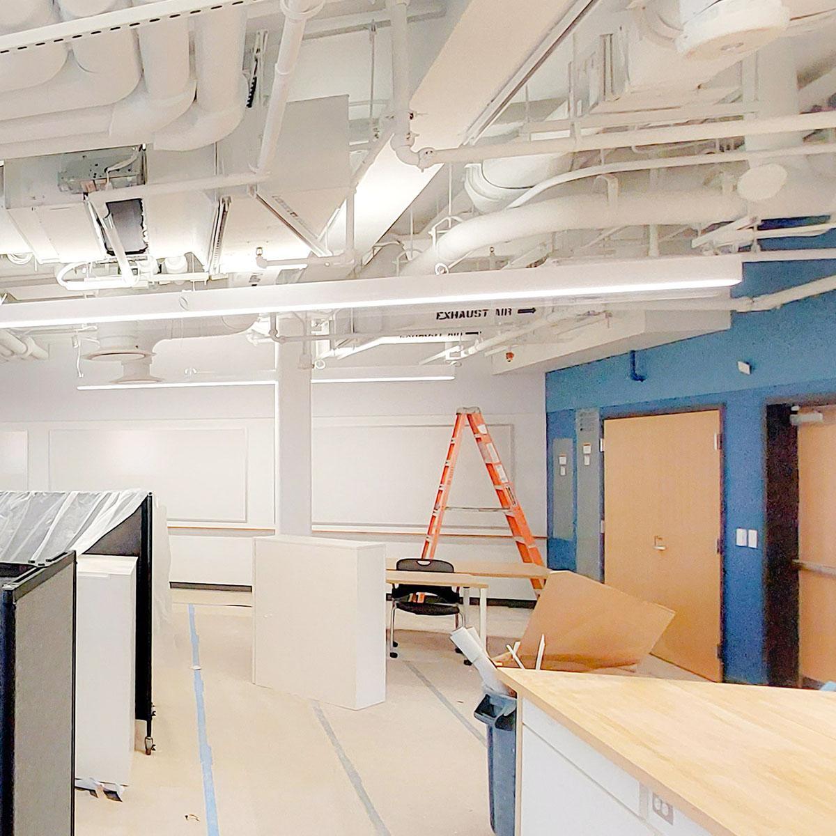Blue Acoustic Felt Wall Panels above the doors and white panels above the whiteboards installed in the UVA Physics building