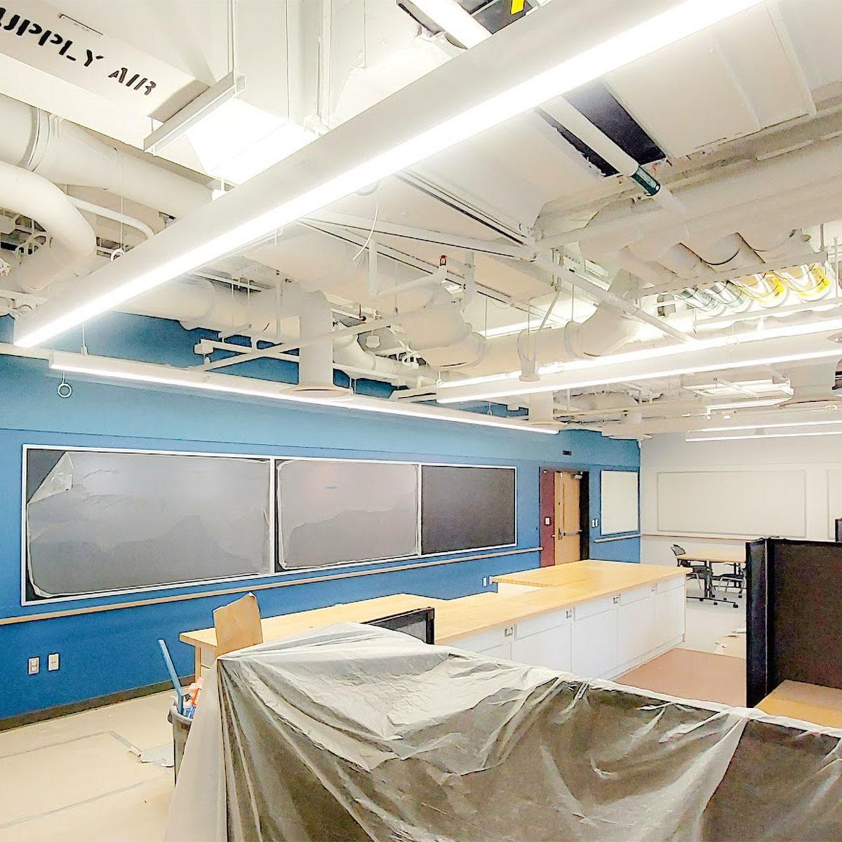Blue Acoustic Felt Wall Panels above the chalkboards and white panels above the whiteboards installed in the UVA Physics building