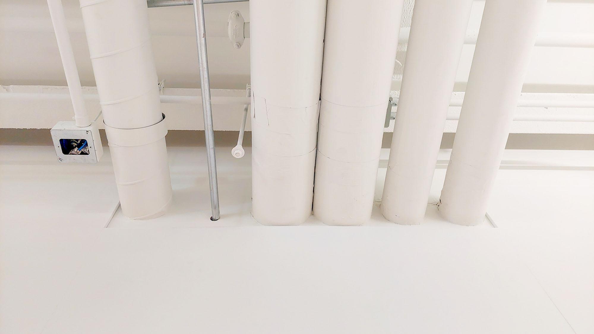 White Acoustic Felt Wall Panels installed in the UVA Physics building surround ductwork and blend in brilliantly
