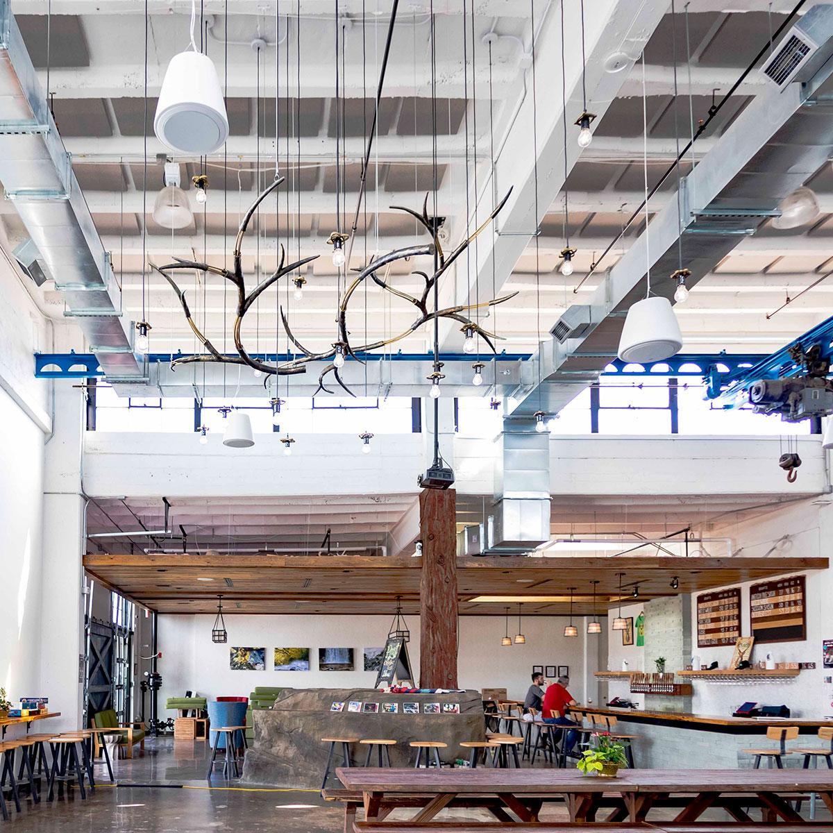 Acoustical panels installed in the ceiling reduce noise in brewery's taproom.