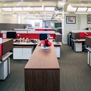 Agati Furniture - Open office plan using red AlphaSorb panels and Sonex Whisperwave Clouds in the ceiling.